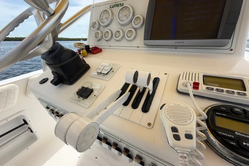 Slide: The Image of Control panel of a 2004 Carrera Boats 27 CC Open, featuring gauges and navigation equipment. - 25
