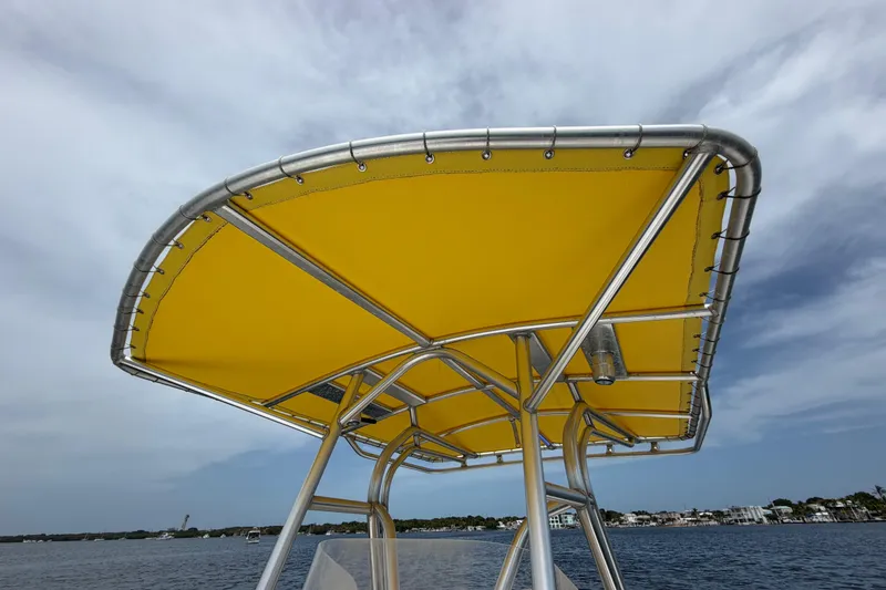 Slide: The Image of Yellow canopy on 2004 Carrera Boats 27 CC Open against a cloudy sky. - 17