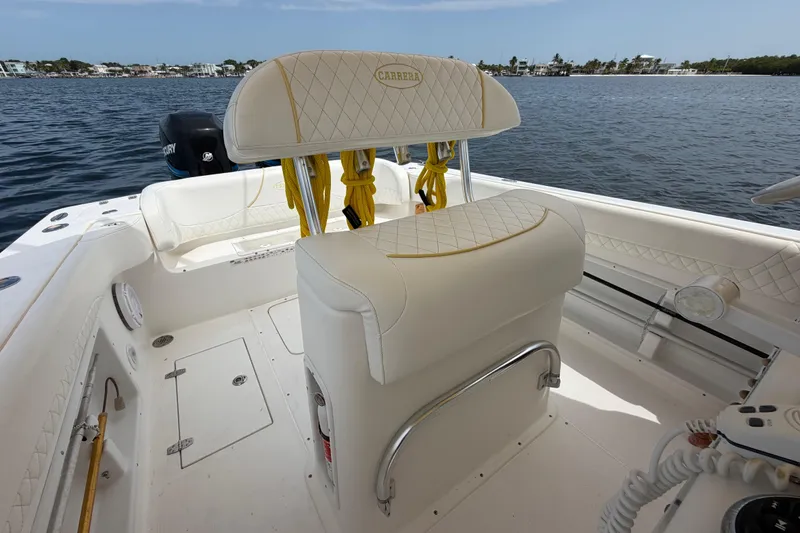Slide: The Image of 2004 Carrera Boats 27 CC Open interior with white seating, on calm water. - 29