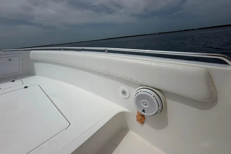 Slide: The Image of 2004 Carrera Boats 27 CC Open interior with speaker, white seating, and ocean view. - 13