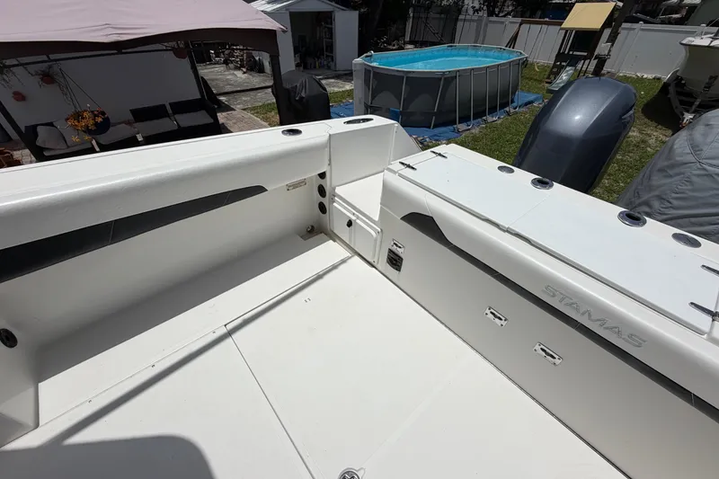 Slide: The Image of 2001 Stamas 270 Express boat deck with seating and storage compartments. - 18