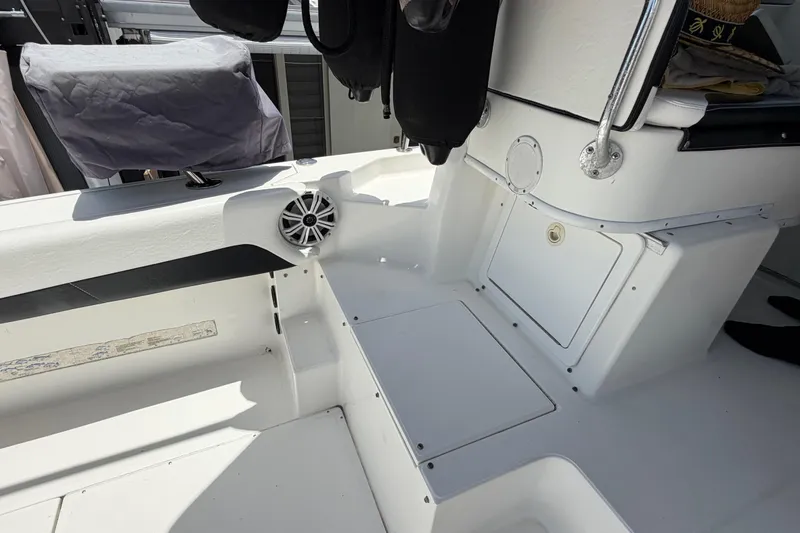 Slide: The Image of Interior view of a 2001 Stamas 270 Express boat, featuring seating and storage compartments. - 21