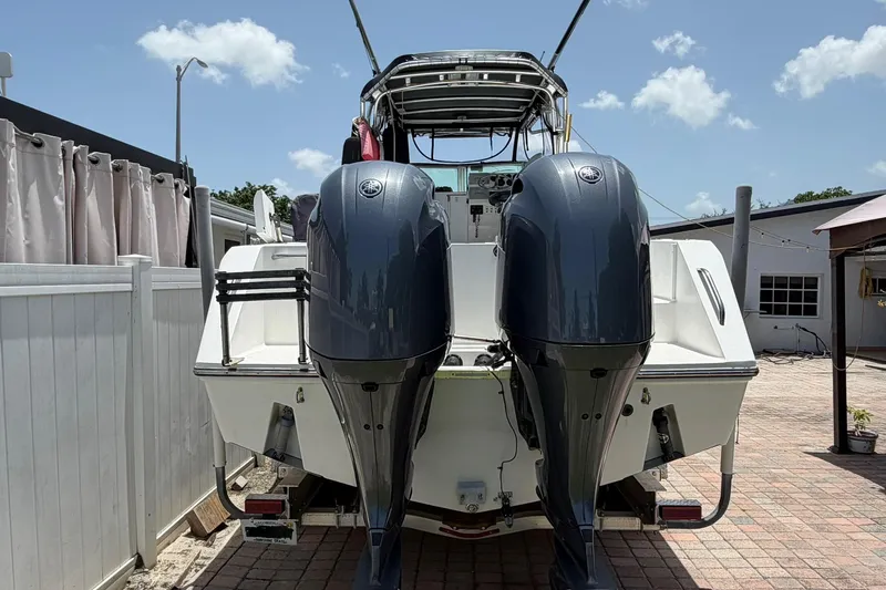 Slide: The Image of 2001 Stamas 270 Express boat with dual outboard motors on a sunny day. - 6