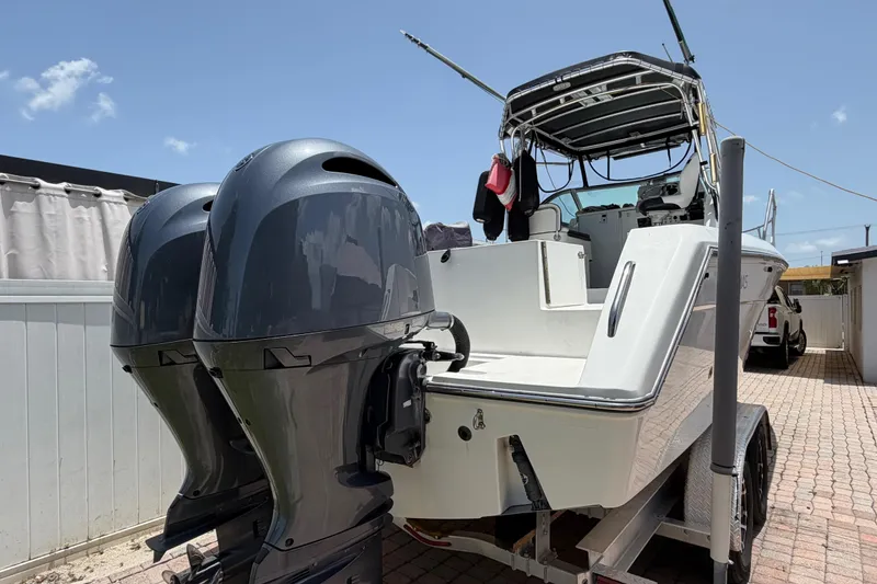Slide: The Image of 2001 Stamas 270 Express boat with dual outboard motors on a trailer. - 7