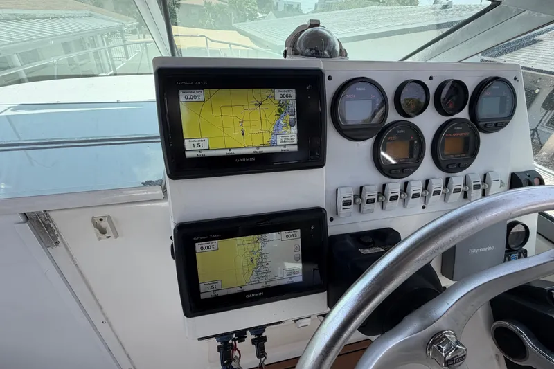 Slide: The Image of Dashboard of a 2001 Stamas 270 Express boat with Garmin navigation displays. - 26