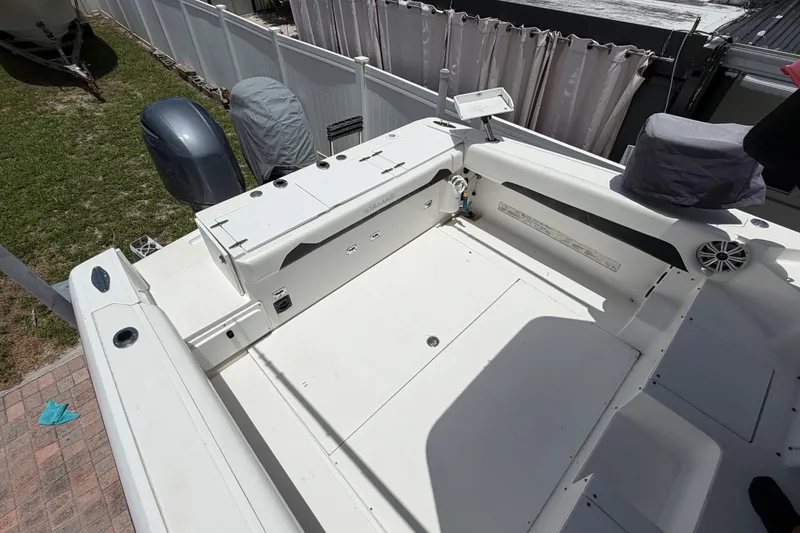 Slide: The Image of 2001 Stamas 270 Express boat deck with covered outboard motor and seating area. - 16