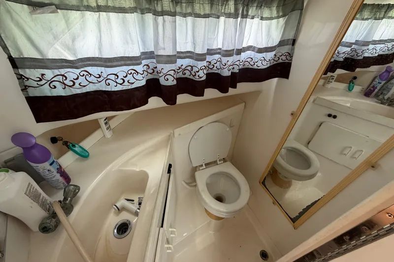 Slide: The Image of Bathroom interior of 2001 Stamas 270 Express boat with toilet, sink, and mirror. - 41