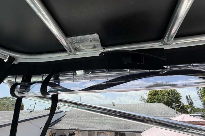 Slide: The Image of Interior view of a 2001 Stamas 270 Express boat, showcasing metal framework and clear canopy. - 34