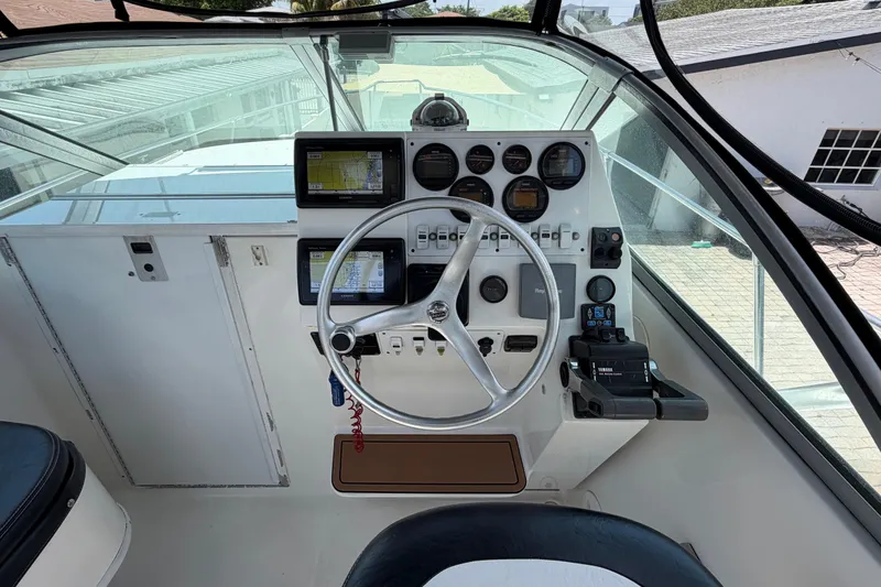 Slide: The Image of Helm of 2001 Stamas 270 Express boat with steering wheel and navigation instruments. - 23