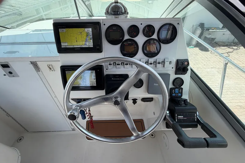 Slide: The Image of Helm of 2001 Stamas 270 Express boat with navigation instruments and steering wheel. - 24