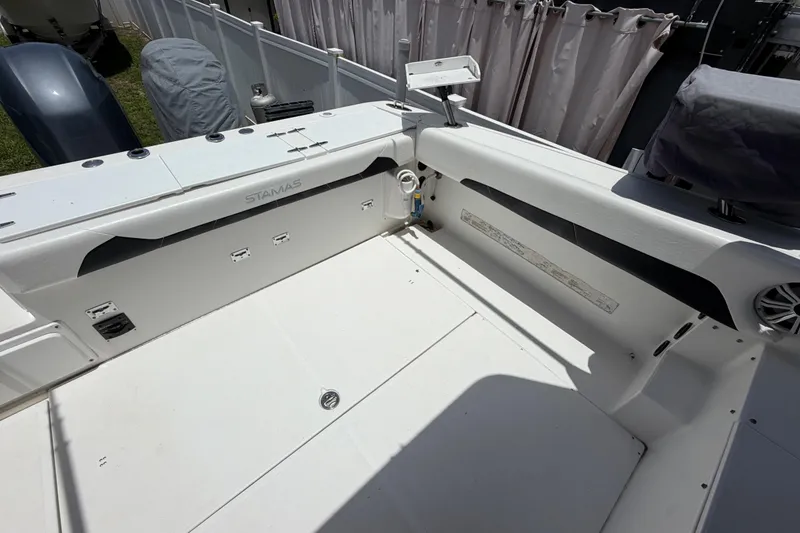 Slide: The Image of 2001 Stamas 270 Express boat deck, featuring spacious seating and storage compartments. - 19