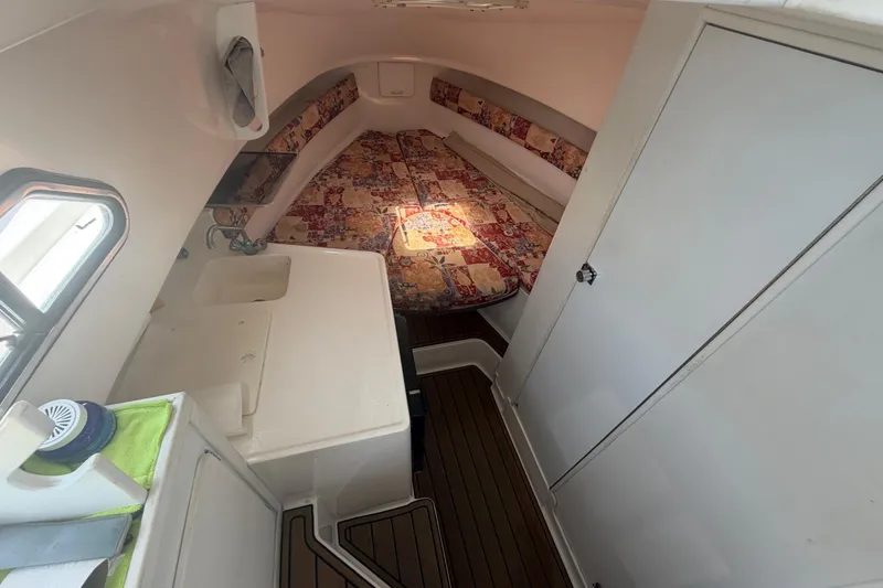 Slide: The Image of Interior of 2001 Stamas 270 Express boat with cozy cabin and patterned bedding. - 35