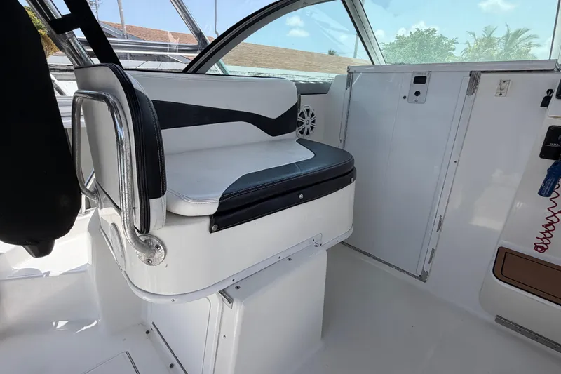 Slide: The Image of Interior of a 2001 Stamas 270 Express boat, featuring a cushioned seat and sleek design. - 30