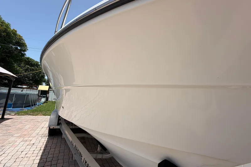 Slide: The Image of 2001 Stamas 270 Express boat on trailer, side view, outdoors under clear sky. - 8