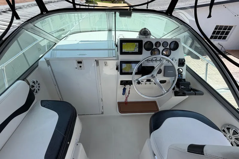 Slide: The Image of 2001 Stamas 270 Express boat cockpit with steering wheel, navigation instruments, and seating. - 22
