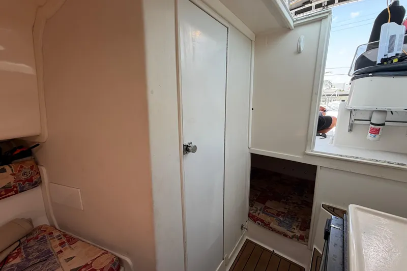 Slide: The Image of Interior cabin of 2001 Stamas 270 Express boat, featuring seating and storage. - 40