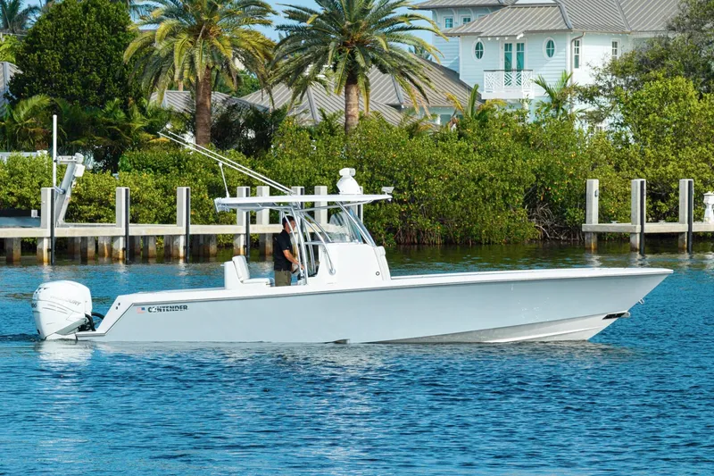 The Image of 2022 Contender 32 ST boat cruising on a sunny day near a tropical shoreline. - 0