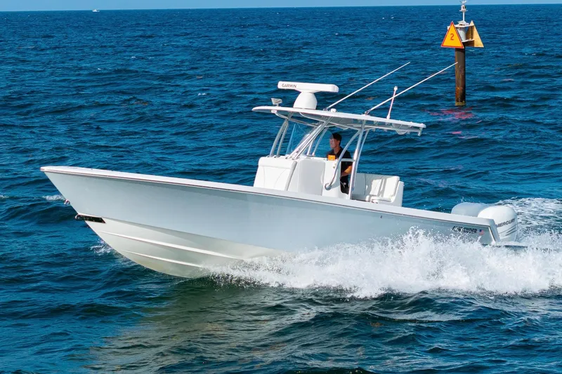 Slide: The Image of 2022 Contender 32 ST boat cruising on open ocean waters. - 17