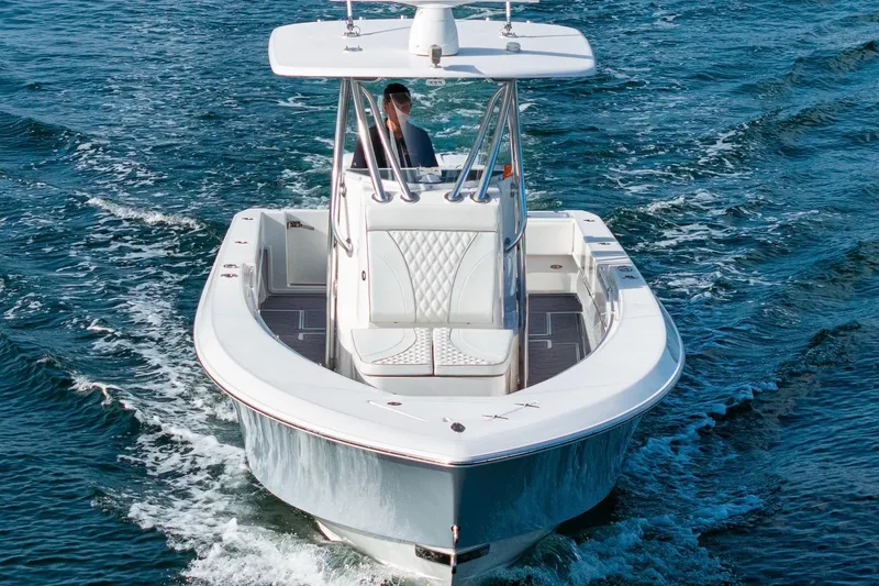 Slide: The Image of 2022 Contender 32 ST boat cruising on open water, showcasing sleek design and performance. - 9