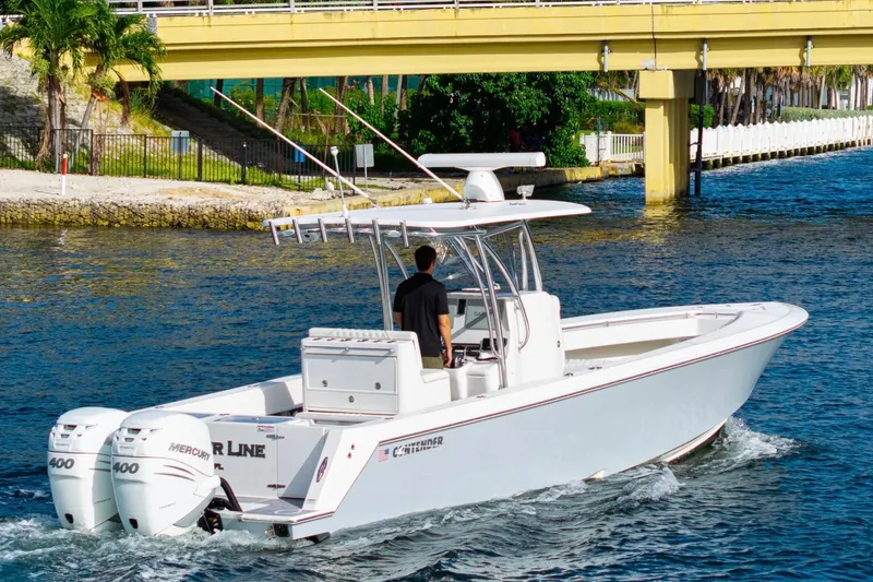 Slide: The Image of 2022 Contender 32 ST boat cruising under a yellow bridge on a sunny day. - 3