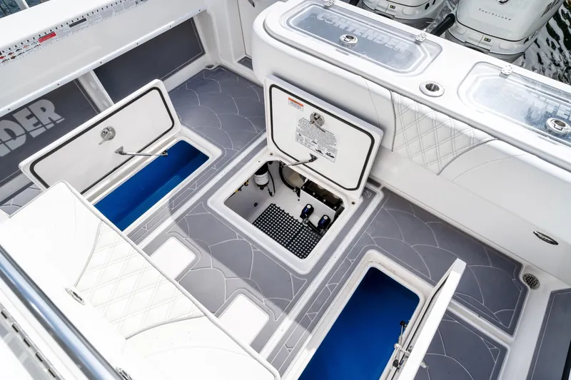 Slide: The Image of 2022 Contender 32 ST boat deck with open storage compartments and sleek design. - 26