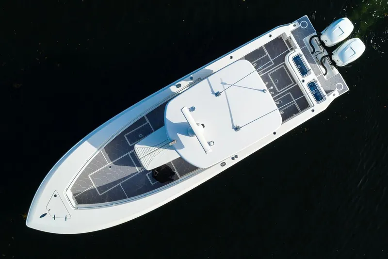 Slide: The Image of Aerial view of 2022 Contender 32 ST boat with dual engines on dark water. - 13