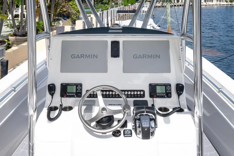 Slide: The Image of 2022 Contender 32 ST boat helm with dual Garmin displays and Mercury controls. - 20