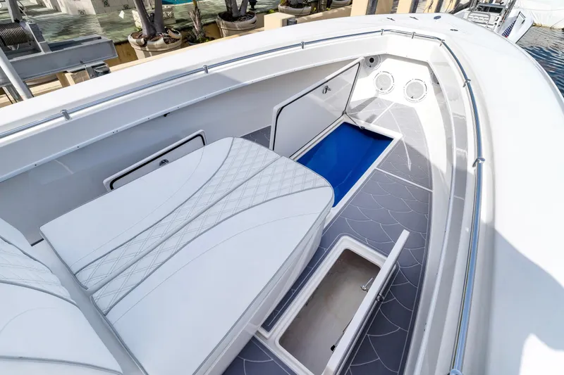 Slide: The Image of 2022 Contender 32 ST boat interior with cushioned seating and storage compartments. - 22