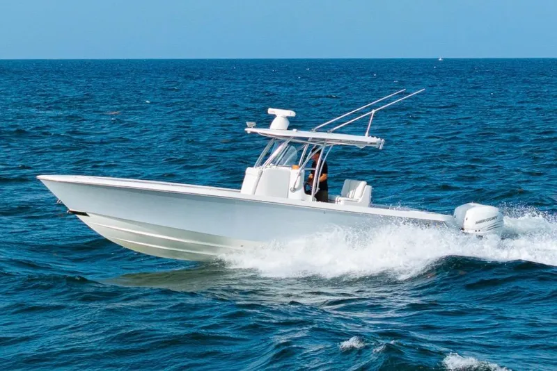 Slide: The Image of 2022 Contender 32 ST boat cruising on open ocean waters. - 2