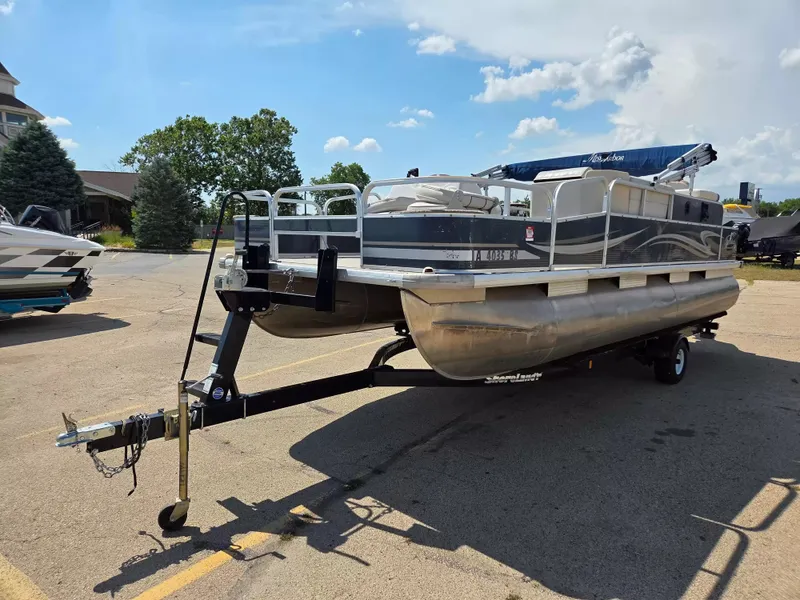 Slide: The Image of A 2010 Misty Harbor 2085 CF pontoon boat on a trailer, parked in a lot. - 6