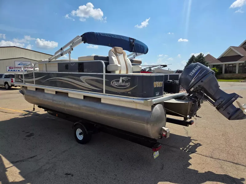 Slide: The Image of A gray Misty Harbor pontoon boat, model 2085 CF, year 2010, is on a trailer. - 3