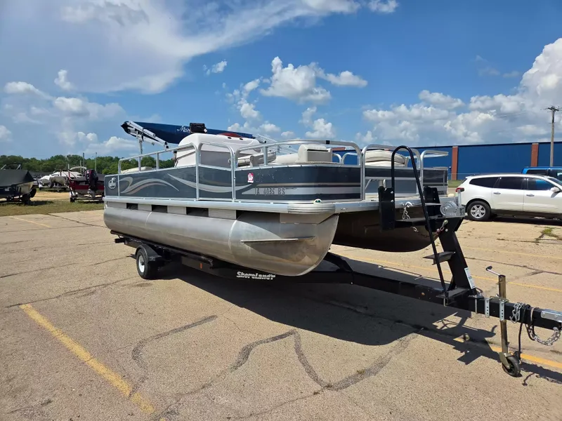 Slide: The Image of A 2010 Misty Harbor 2085 CF pontoon boat on a trailer in a parking lot. - 5