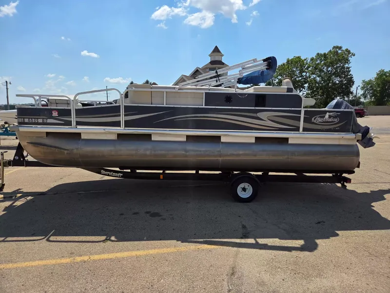 Slide: The Image of A 2010 Misty Harbor 2085 CF pontoon boat on a trailer in a parking lot. - 4