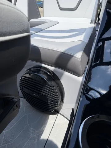 Slide: The Image of Close-up of a speaker in a modern boat with gray and white upholstery. - 11
