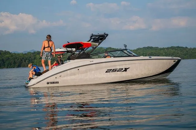 Slide: The Image of 2026 Yamaha 252XE on a calm lake with several people on board. - 16