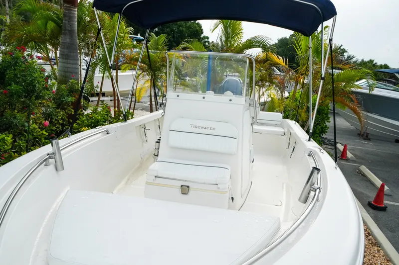 Slide: The Image of 2011 Tidewater 196 CC Adventure boat with canopy, surrounded by tropical plants. - 11