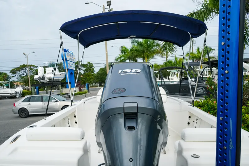 Slide: The Image of 2011 Tidewater 196 CC Adventure boat with 150 HP engine, parked outdoors. - 7