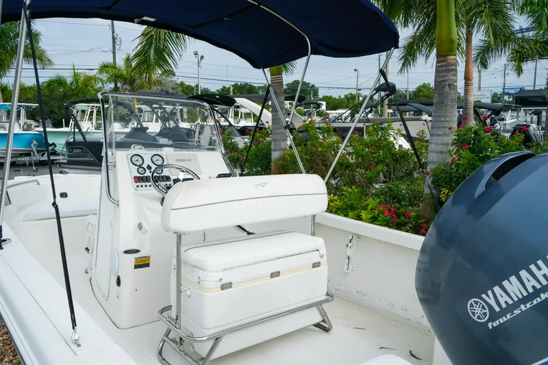 Slide: The Image of 2011 Tidewater 196 CC Adventure boat with Yamaha engine, surrounded by tropical plants. - 10