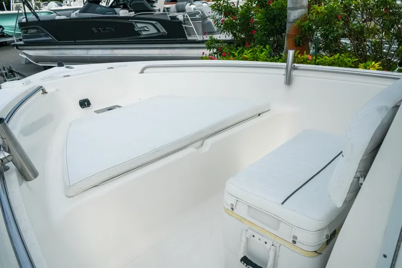 Slide: The Image of 2011 Tidewater 196 CC Adventure boat interior with white seating and storage. - 14