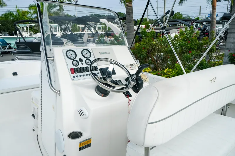 Slide: The Image of 2011 Tidewater 196 CC Adventure boat dashboard with steering wheel and control panel. - 15