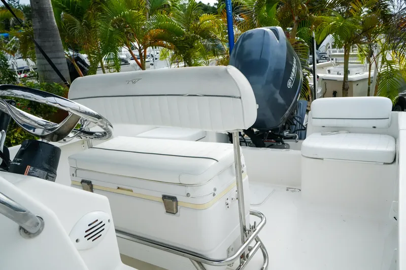 Slide: The Image of 2011 Tidewater 196 CC Adventure boat interior with white seating and Yamaha outboard motor. - 12