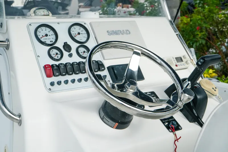 Slide: The Image of Steering console of 2011 Tidewater 196 CC Adventure boat with gauges and controls. - 16