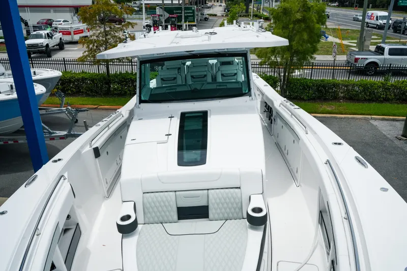 Slide: The Image of 2025 Blackfin 400 CC boat with sleek white design and spacious seating area. - 23