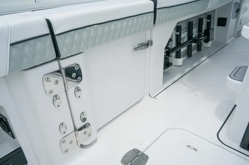 Slide: The Image of 2025 Blackfin 400 CC boat interior with sleek white seating and storage compartments. - 11
