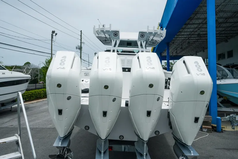 Slide: The Image of 2025 Blackfin 400 CC boat with four powerful 400 V10 engines at a marina. - 4