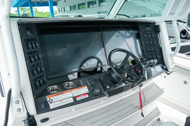 Slide: The Image of 2025 Blackfin 400 CC boat dashboard with advanced controls and navigation system. - 16