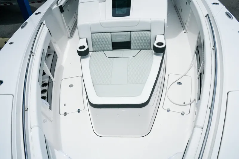 Slide: The Image of 2025 Blackfin 400 CC boat interior with cushioned seating and cup holders. - 22