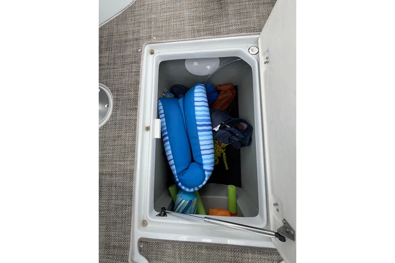 Slide: The Image of Storage compartment in 2018 Crownline 285 SS boat with pool floats and accessories. - 22