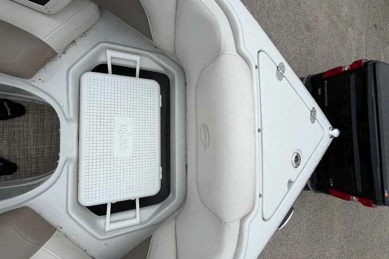 Slide: The Image of 2018 Crownline 285 SS boat with Igloo cooler in storage compartment. - 20