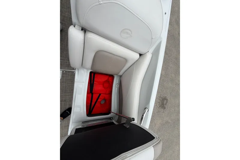 Slide: The Image of 2018 Crownline 285 SS boat seat storage with red life jackets visible. - 18